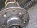 1995 Ford C-350 (Centurion Conversions) - Close-up view of a rusty wheel hub assembly, showing wear and tear on the metal components.