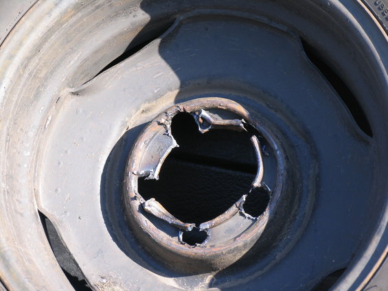 Damaged wheel rim with cutouts around the center