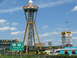 1995 Ford C-350 (Centurion Conversions) - South of the Border attraction with its iconic sombrero tower and various roadside businesses under a partly cloudy sky.