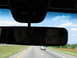 1995 Ford C-350 (Centurion Conversions) - Driving on the highway with a digital display showing 80 degrees and NE, with reflections of passengers in the rearview mirror.