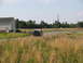 1995 Ford C-350 (Centurion Conversions) - A classic Ford F-Series truck drives down a country road, with another vehicle in the background.