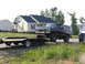 1995 Ford C-350 (Centurion Conversions) - Ford Bronco towing a trailer down a residential street.