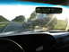 1995 Ford C-350 (Centurion Conversions) - View from inside a vehicle, looking at a trailer carrying a Ford Bronco on the highway.