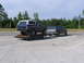 1995 Ford C-350 (Centurion Conversions) - Two Ford SUVs are visible, one a Bronco on a trailer and the other towing it.