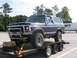 1995 Ford C-350 (Centurion Conversions) - 1978 Ford Bronco being transported on a trailer, aftermarket modifications and a website sticker.