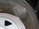 1995 Ford C-350 (Centurion Conversions) - Close-up of a tire and wheel assembly, showing branding and decorative stripes on the wheel.