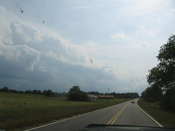 Driving down a two-lane road in the countryside with a car ahead