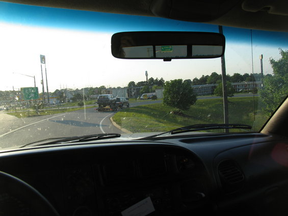 Two SUVs on a trailer being towed on a highway
