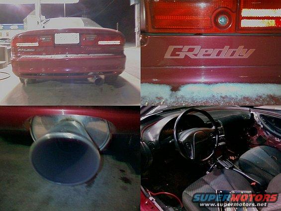 Red coupe rear view with large exhaust tip and GReddy badge