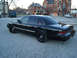 1992 Ford Crown Victoria - Black 1992 Ford Crown Victoria sedan seen from the rear three-quarter angle on a paved lot.