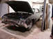 1992 Ford Crown Victoria - Front view of a 1966 Ford Thunderbird coupe in a garage, hood up revealing the engine.