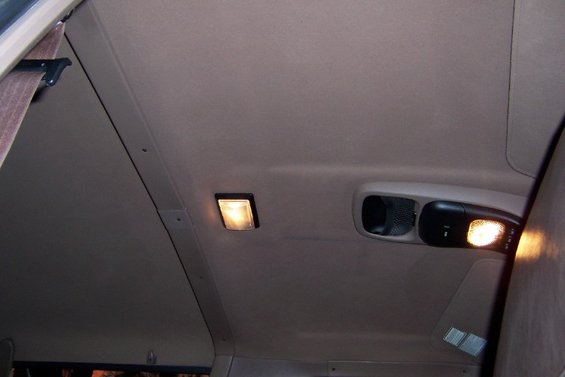 Interior ceiling of a vehicle with two lights and a vent