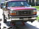 1996 Ford Bronco - Front view of a 1996 Ford Bronco being worked on, lifted on jack stands.
