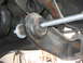 1996 Ford Bronco - Suspension component with a threaded rod installed, likely part of a lift kit modification.