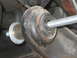 1996 Ford Bronco - A threaded bolt is being installed through a rubber bushing as part of a suspension lift.