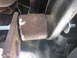 1996 Ford Bronco - Detail of a suspension component, likely during a lift installation, showing rust and a new bolt.