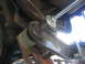 1996 Ford Bronco - Installation of a suspension part, showing a threaded rod and hardware.