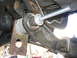 1996 Ford Bronco - A close-up view of a vehicle's suspension system, showing a modified component with a threaded rod.