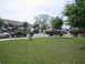 1996 Ford Bronco - A dark green 1996 Ford Bronco is parked on a suburban street alongside other vehicles.