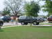 1996 Ford Bronco - A 1996 Ford Bronco is parked on a suburban street alongside other vehicles.