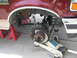 1996 Ford Bronco - The front wheel assembly of a 1996 Ford Bronco is elevated on jack stands for maintenance.