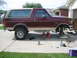 1996 Ford Bronco - Side view of a 1996 Ford Bronco undergoing maintenance, lifted on jack stands.