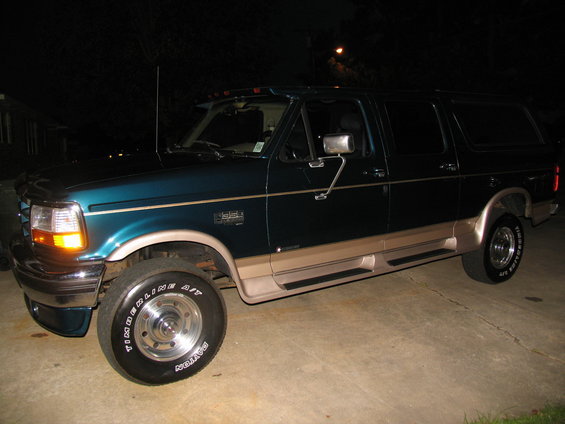 1995 Ford C-350 Centurion Conversions SUV, teal and tan two-tone paint, side view
