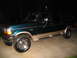 1995 Ford C-350 (Centurion Conversions) - This 1995 Ford C-350 Centurion Conversions SUV is seen from the side at night.