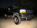 1995 Ford C-350 (Centurion Conversions) - Front 3/4 view of a 1995 Ford Bronco parked outdoors at night.