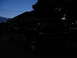 1995 Ford C-350 (Centurion Conversions) - A dark Ford F-Series truck is parked outside at twilight, with trees and a street light in the background.