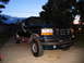 1995 Ford C-350 (Centurion Conversions) - This 1995 Ford C-350 Centurion Conversions SUV is shown in a three-quarter front view at dusk.