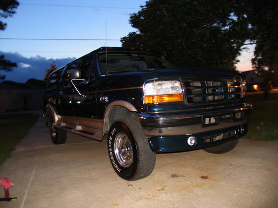 1995 Ford C-350 Centurion Conversions SUV parked on driveway at dusk