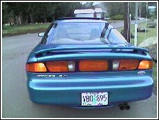 1996 Ford Probe GT rear view, teal paint, spoiler, GT badge on taillight panel