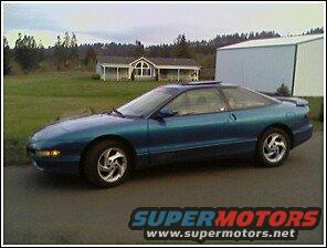 Teal Ford Probe parked outside a house