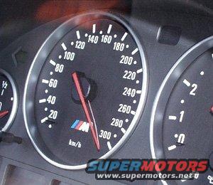 Close-up of car's speedometer and tachometer gauges. Speedometer goes up to 300 km/h