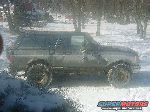 Gray Ford Bronco in snow, side view