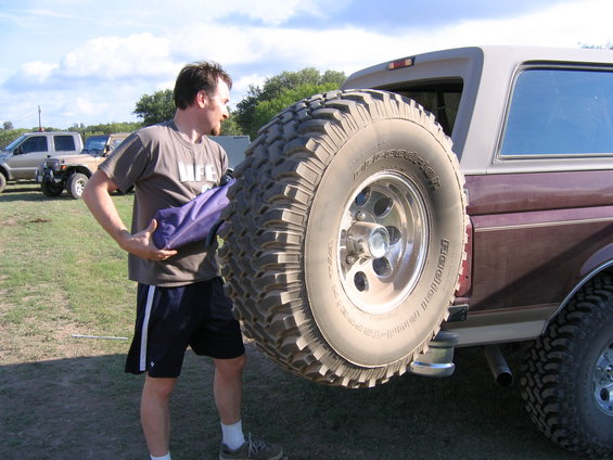 1996 Ford Bronco rear view with spare tire and man holding bag