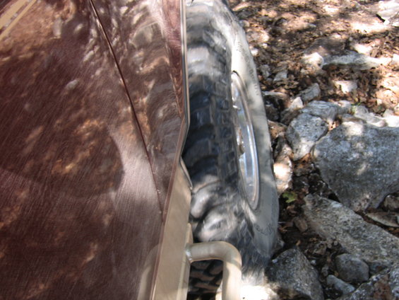 Side view of a 1996 Ford Bronco tire on rocky ground