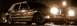 1989 Lincoln Town Car - A dark 1989 Lincoln Town Car is illuminated by headlights at night, viewed from a low 3/4 front angle.