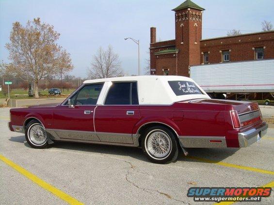 Red 1989 Lincoln Town Car with white vinyl roof, rear 3/4 view. "Just Married" written on rear window