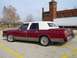 1989 Lincoln Town Car - This 1989 Lincoln Town Car, seen from the rear 3/4 angle, features a two-tone red and white color scheme and "Just Married" written on the…
