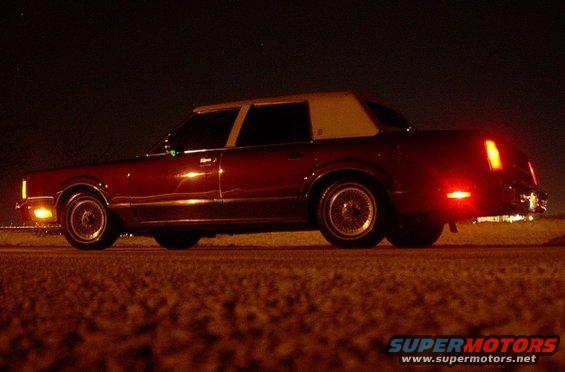1989 Lincoln Town Car, side view at night, maroon with tan vinyl top