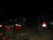 1996 Ford Bronco - Nighttime scene with people, a trailer, and a red SUV, camping chairs are set up.