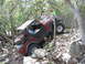 1996 Ford Bronco - Off-road vehicle navigating a challenging, rocky path with onlookers.