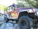 1996 Ford Bronco - A man drives a maroon Jeep Wrangler over a rocky trail, with another Jeep following behind.
