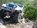 1996 Ford Bronco - White Jeep CJ-7 navigates a rocky trail during an off-road excursion.