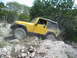 1996 Ford Bronco - Jeep Wrangler Rubicon navigating a challenging rocky off-road course.