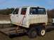 1992 Lincoln Custom - A detached truck cab is secured with straps to a trailer, ready for transport.