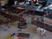 1992 Lincoln Custom - A heavily rusted vehicle frame is disassembled on a workshop floor, surrounded by tools and equipment.
