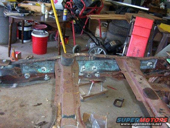 rusted vehicle frame with bolts and rubber mounts